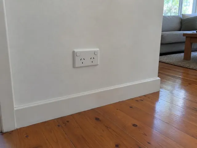 White double power point on a painted wall above a timber floor in Bensville